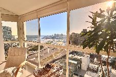 Living luminoso con ventanales y vista al mar